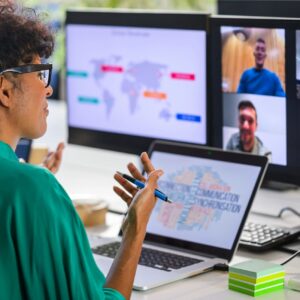 Woman discussing report with remote workers