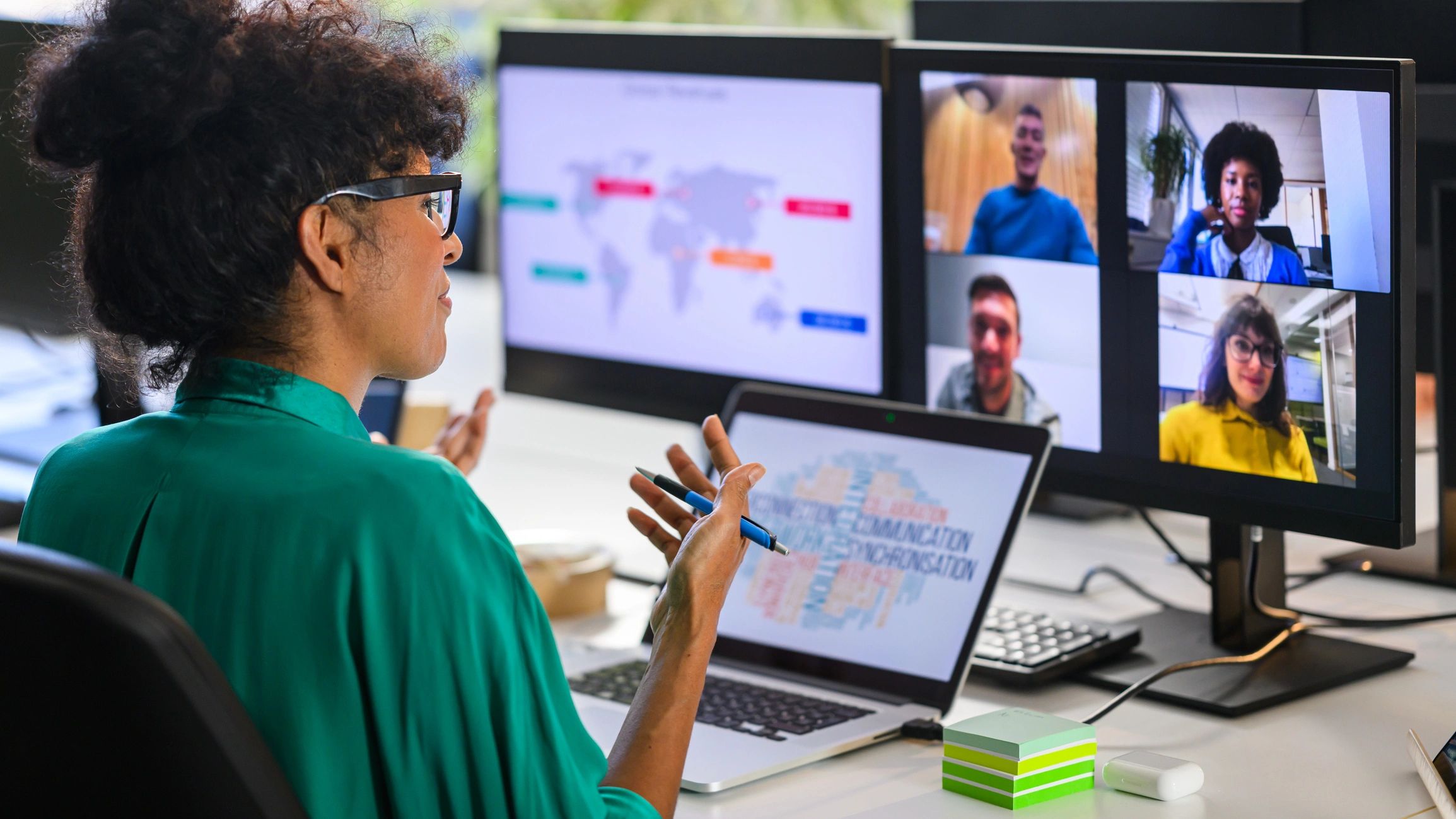 Woman discussing report with remote workers
