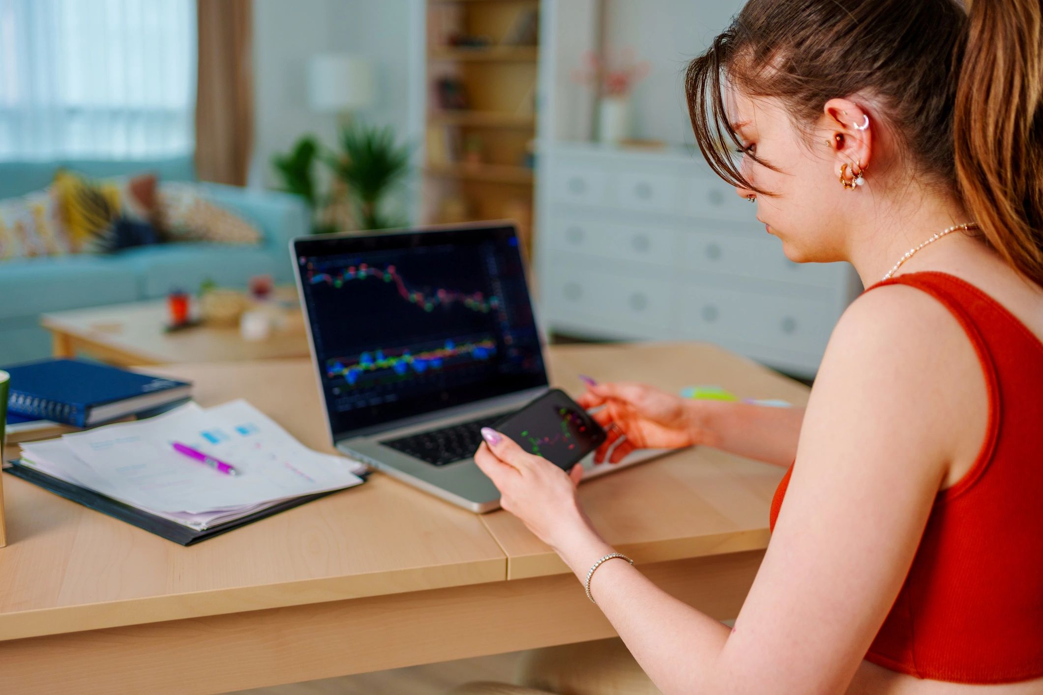Learner reviewing financial data and taking notes on a laptop