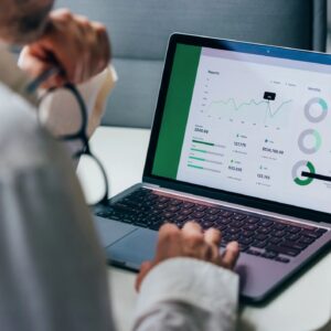 Professional Analyzing Business Data on Laptop with Graphical Charts and Reports
