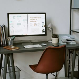 Home Office Workspace Displaying Marketing Analytics Dashboard